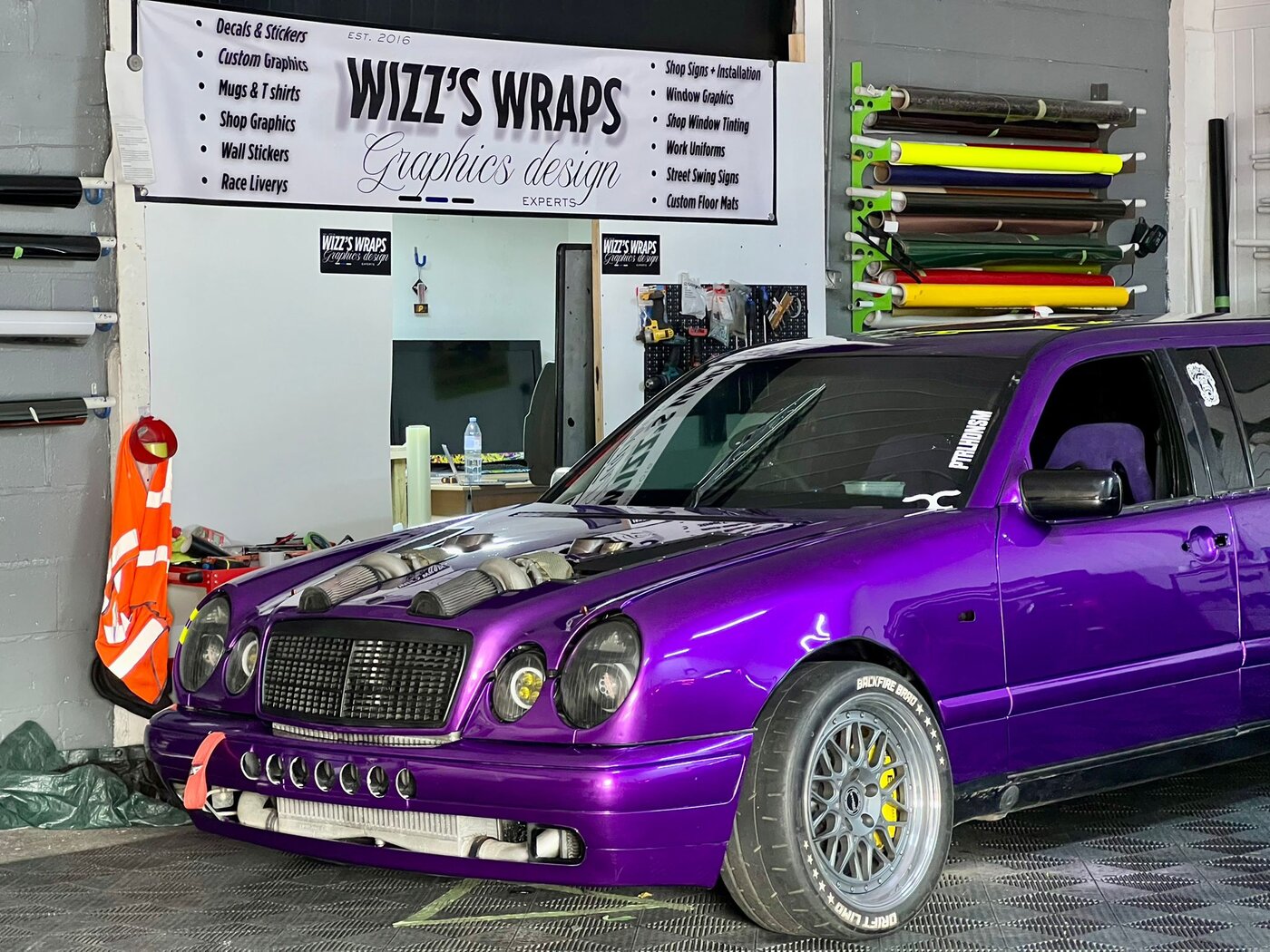 Side view of drift limo with purple wrap in the Wizz's Wraps workshop