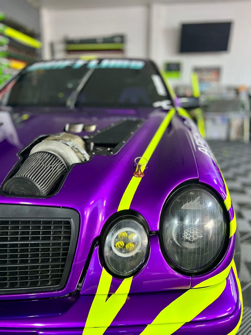 Front angle of the drift limo with custom neon graphics and twin turbo setup