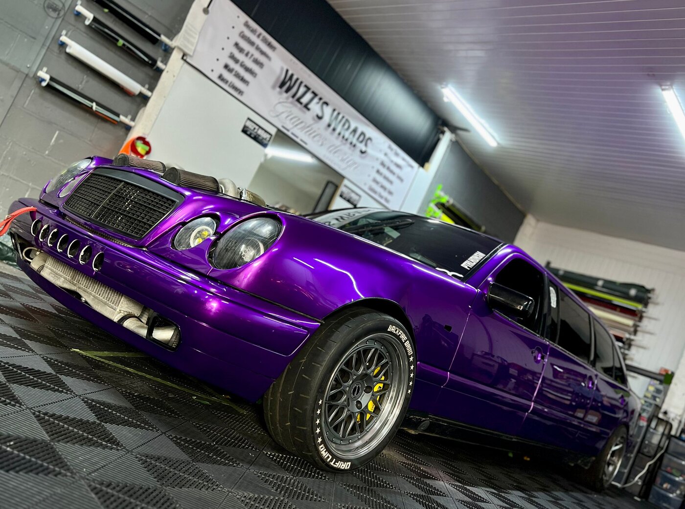 The drift limo with fresh purple base wrap applied, front three-quarter angle