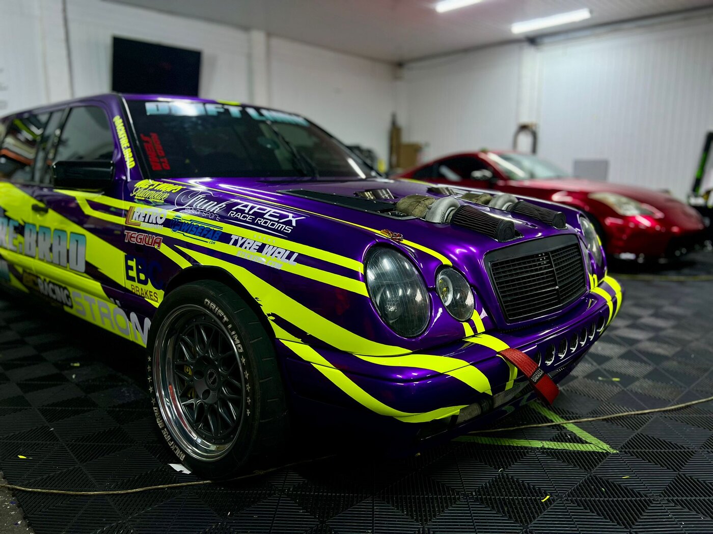 Three-quarter front view of the finished drift limo with all graphics installed