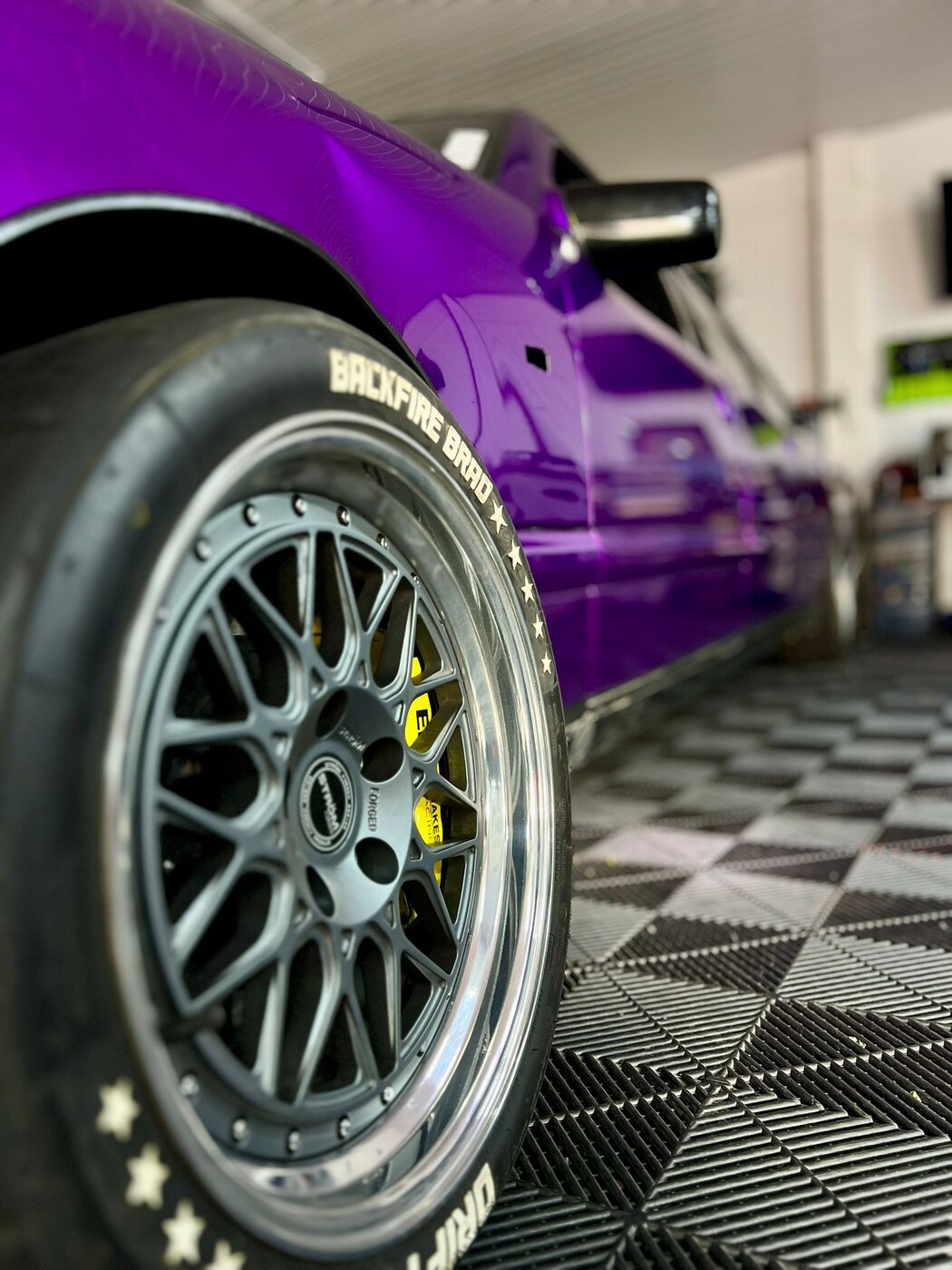 Detail shot of wheel, tyre and fender with graphics on the drift limo
