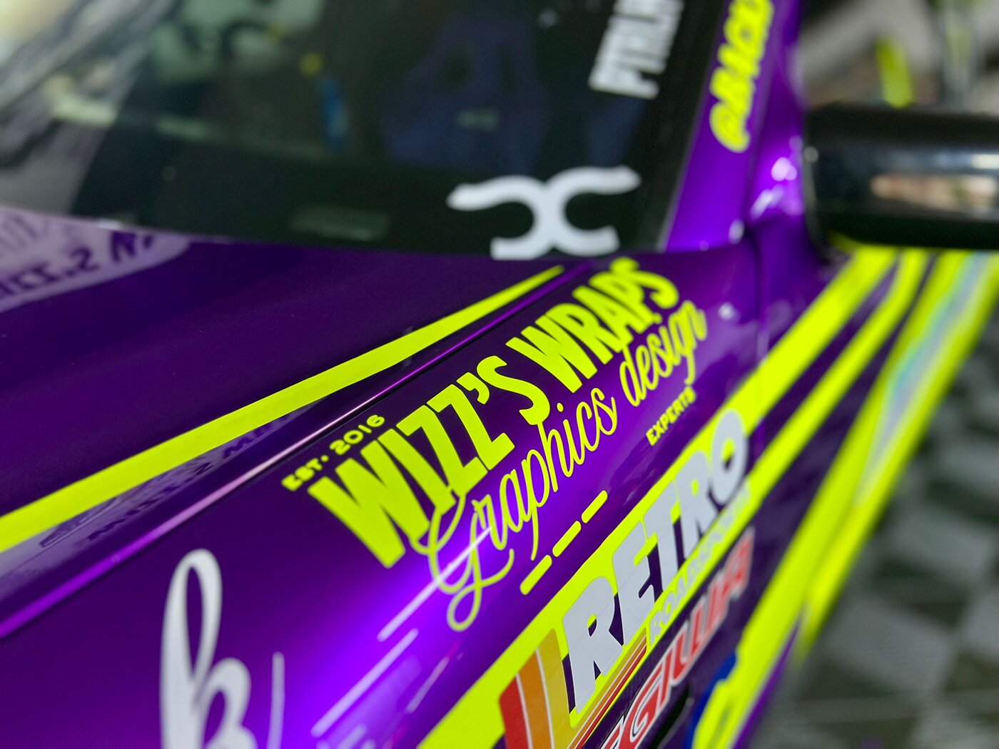 Close-up of Wizz's Wraps branding on the drift limo