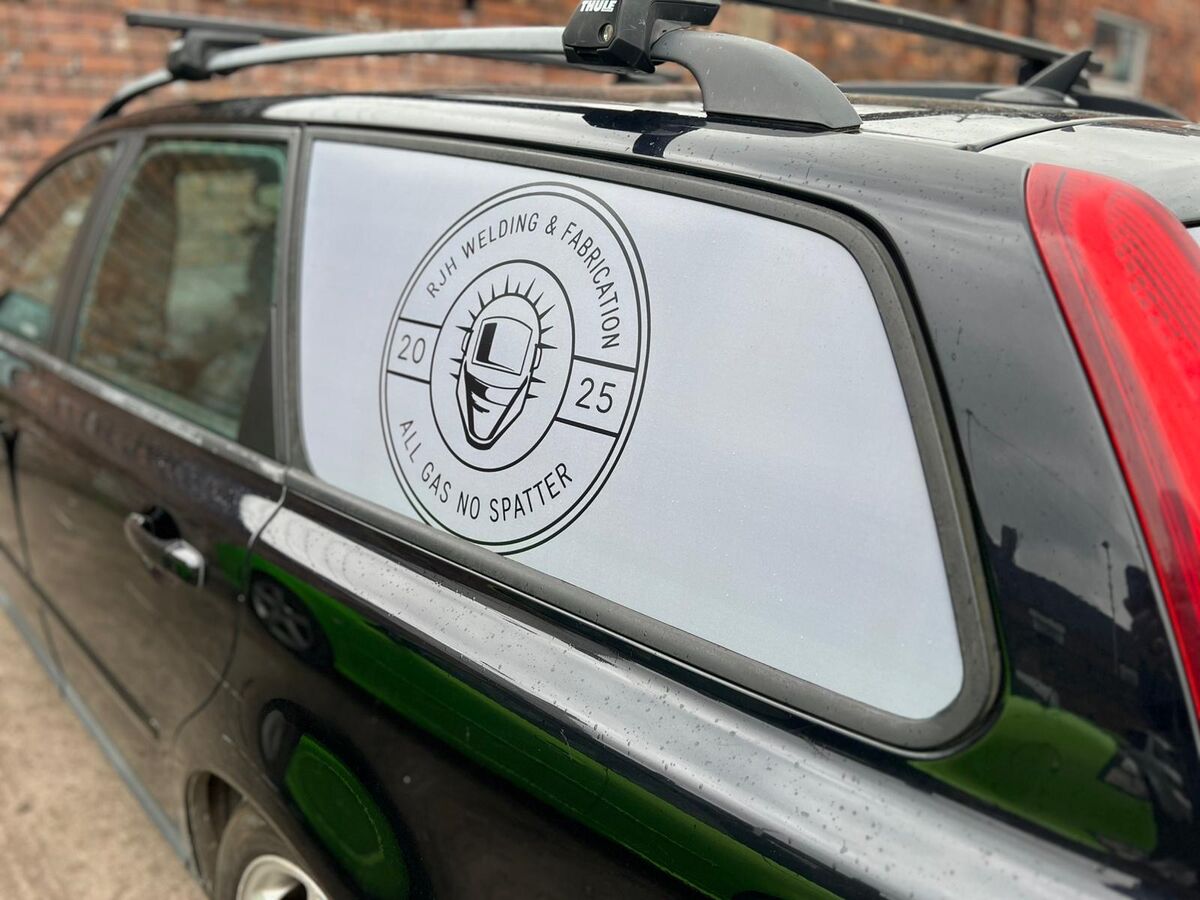 RJH Welding and Fabrication logo vinyl graphic on Volvo V50 side window close-up
