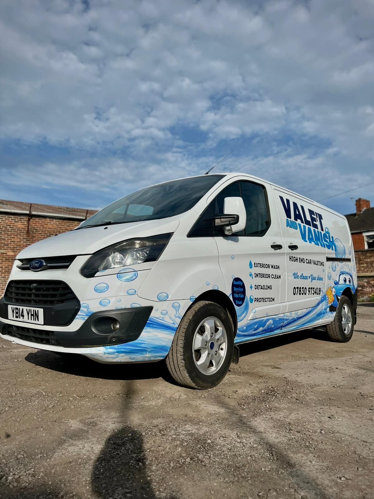 Valet and Vanish Ford Transit Custom van wrap front view with dramatic cloudy sky background